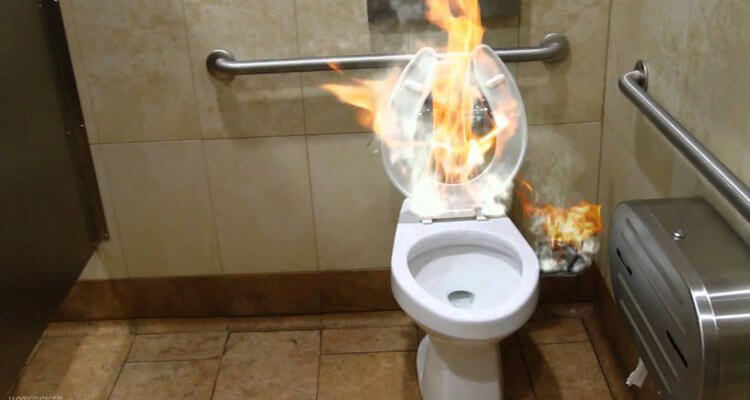 Stupid friend sets his buddy on fire while in the bathroom